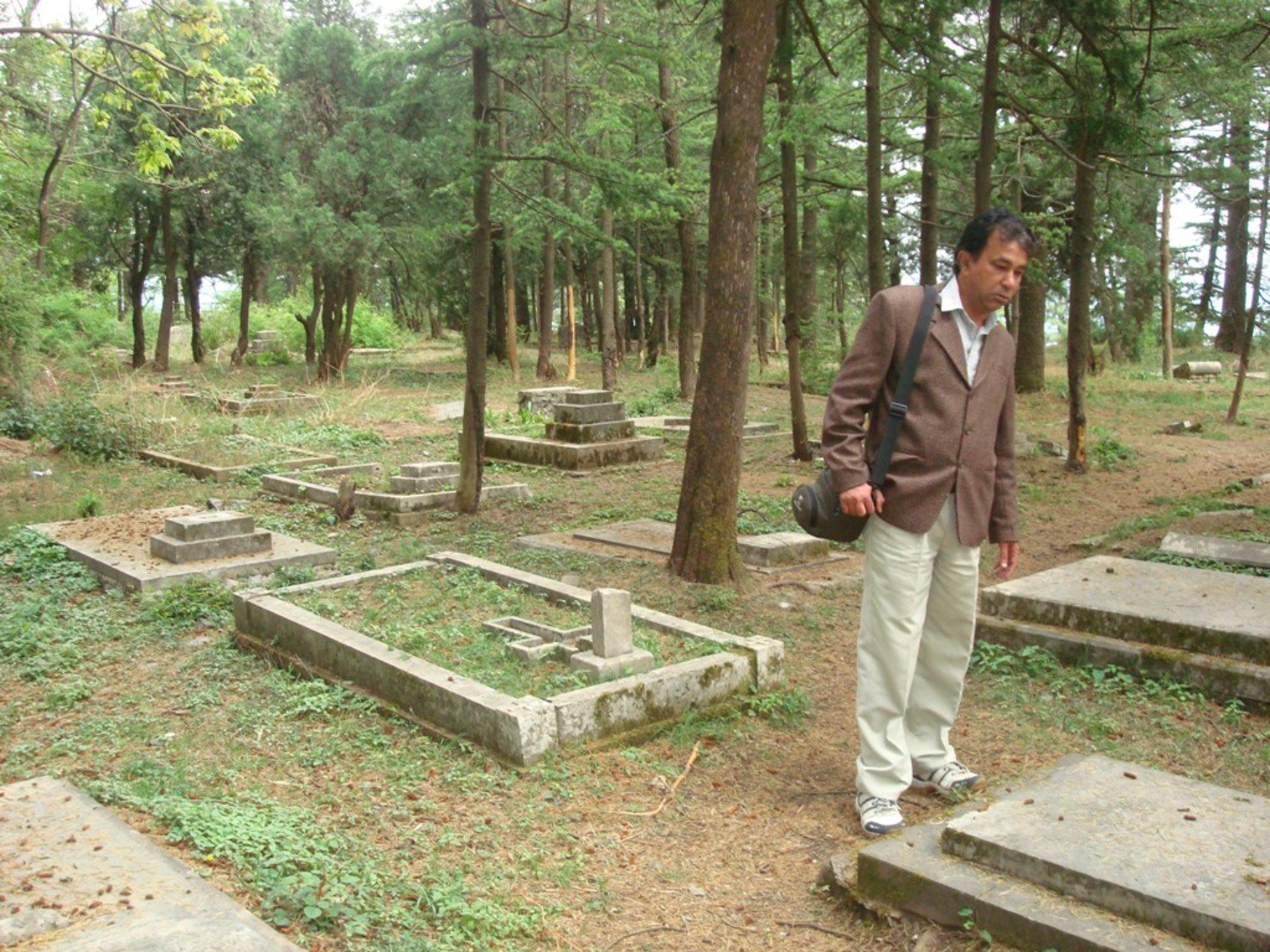 Looking at a grave in a cemetery in Shimla
